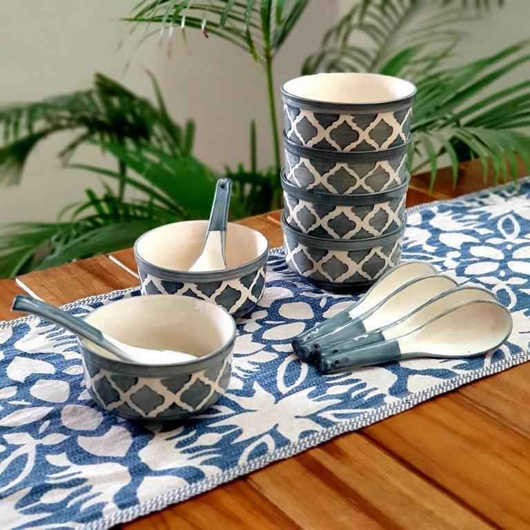 Grey hand-painted ceramic soup bowls with spoons